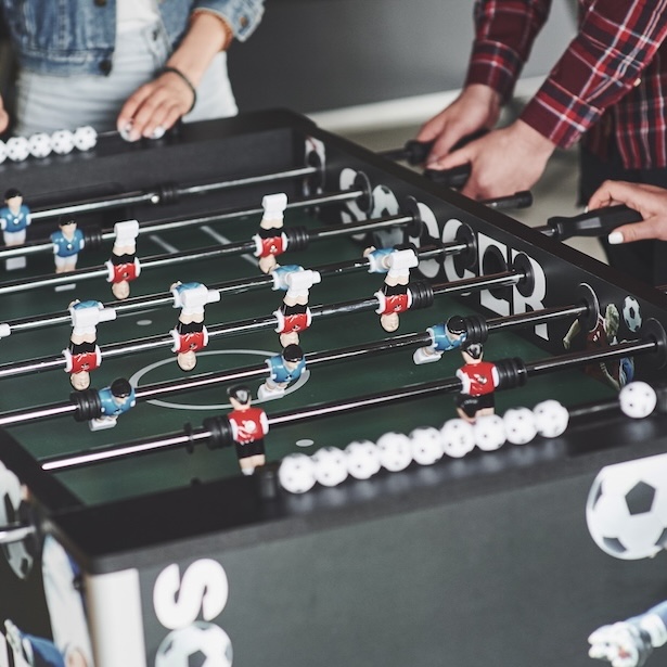 Friends together play board games, table football